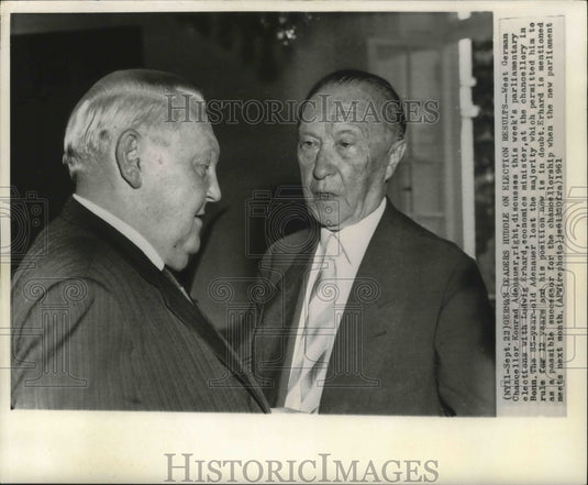 1961 German Leaders Adenauer & Erhard huddle on election results - Historic Images