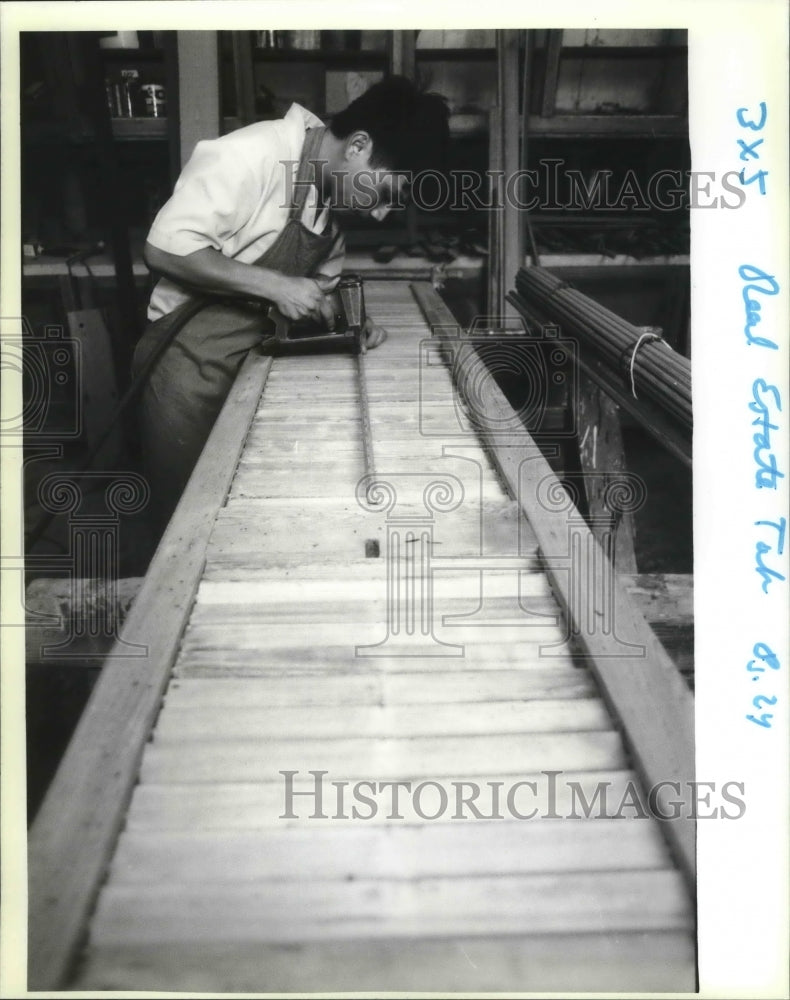 1990 Prak Chan Sarath works on shutters at Addco - Historic Images