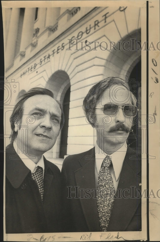 Newsmen Gibb Adams, left, and Larry Dickinson leave court. - Historic Images