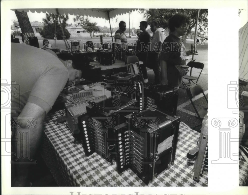 1992 Accordian Fest- Shopper checks out accordians for sale. - Historic Images