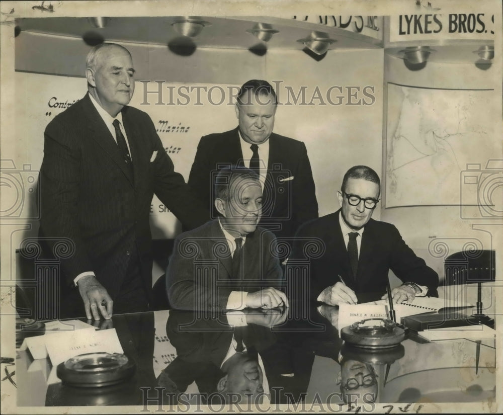 1961 Press Photo Donald Alexander and others sign contracts at Avondale. - Historic Images