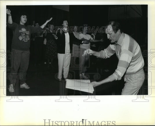 1989 Charles Alder leads choral group at Shepherd's Fold Church. - Historic Images