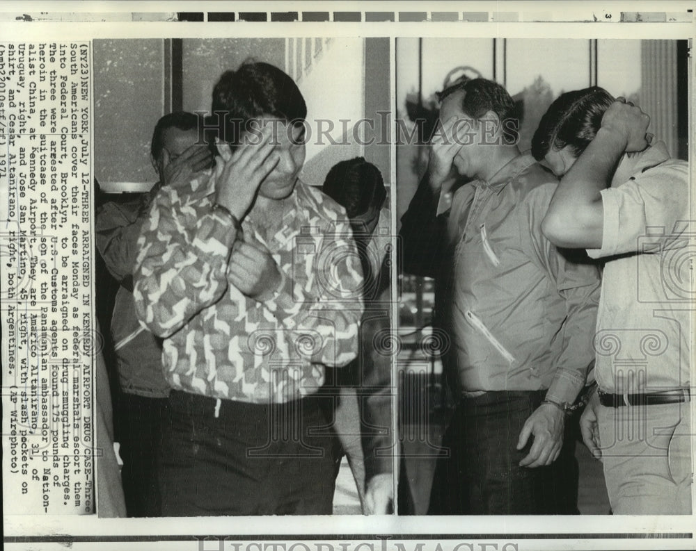 1971 Press Photo South Americans cover their faces during escort by marshals - Historic Images