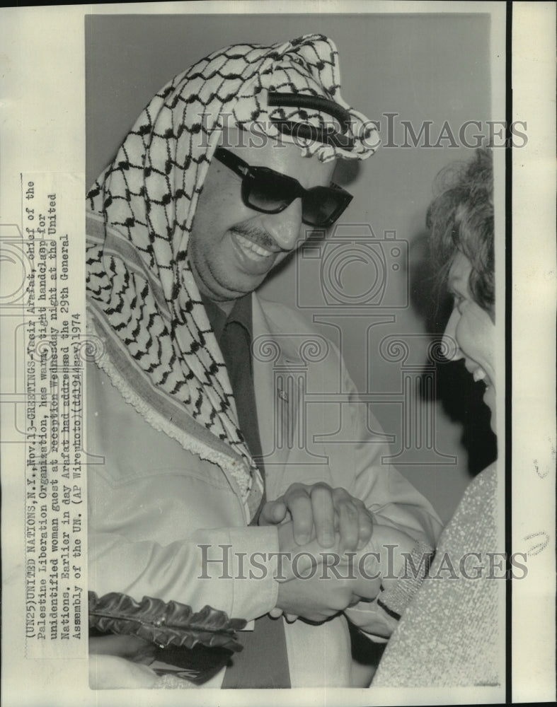 1974 Press Photo Yasir Arafat Clasps Hands with Woman at United Nations-Historic Images