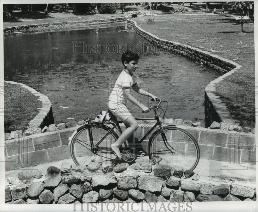 1972 Boy Bicycles Next to Water in Audubon Park - Historic Images