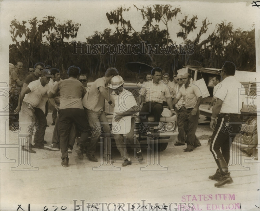 1969 An auto shoves picketers at Brown &amp; Root construction site-Historic Images