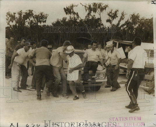 1969 An auto shoves picketers at Brown & Root construction site-Historic Images