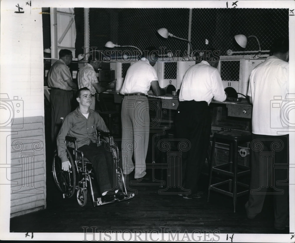 1961 Herb Cavalier rolls past parimutuel clerks at Fair Grounds - Historic Images