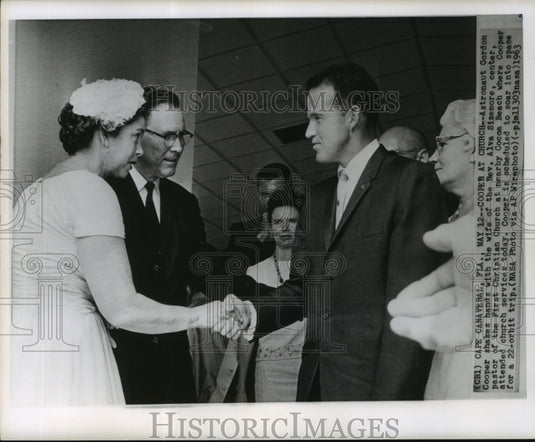 1963 Astronaut Gordon Cooper shakes hands with Reverend's wife - Historic Images
