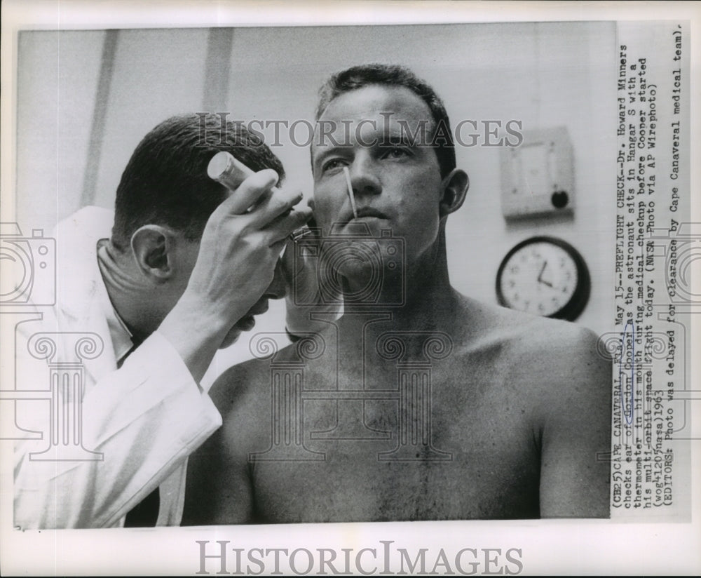 1963 Dr. Howard Minners check ear of Gordon Cooper - Historic Images