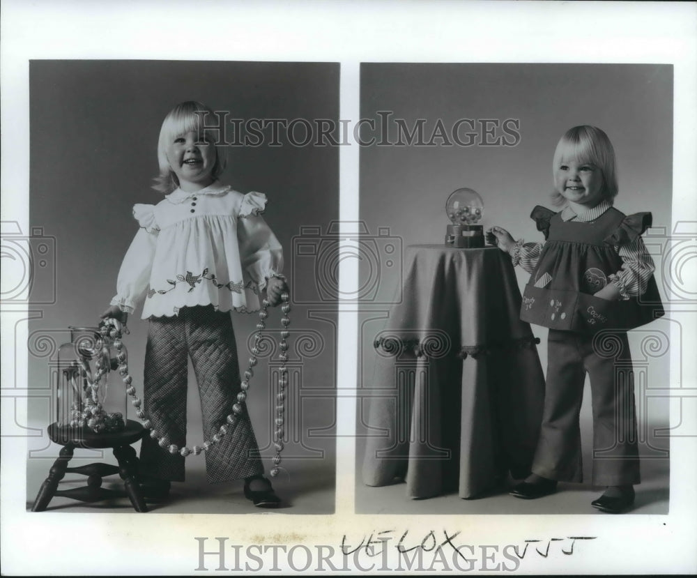 1974 Angel with Christmas decoration in jar and snowglobe. - Historic Images