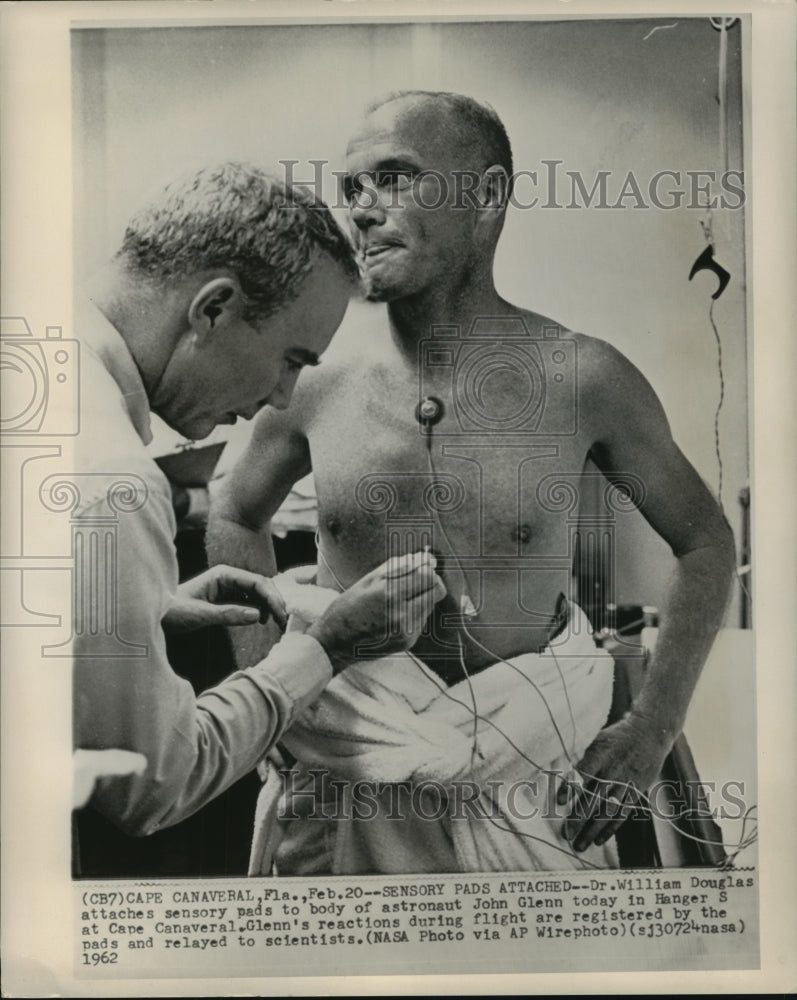 1962 Press Photo Dr. William Douglas attaches sensory pads to body of John Glenn - Historic Images