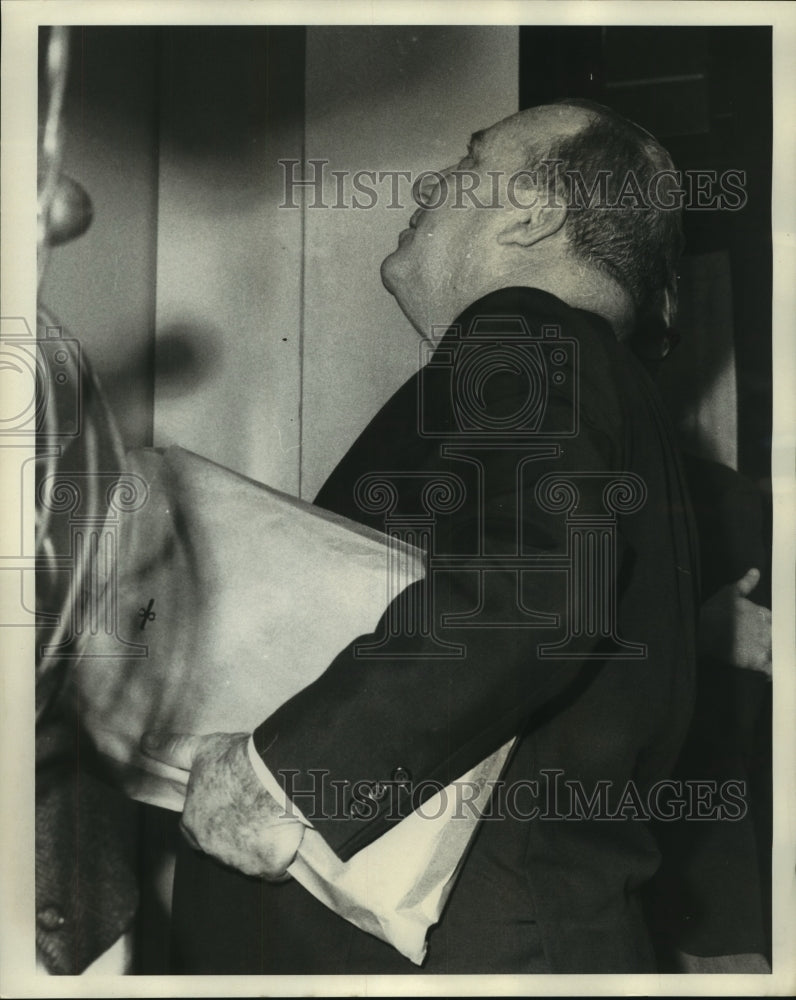 1968 Jack P.F. Gremillion waits for elevator with his records - Historic Images