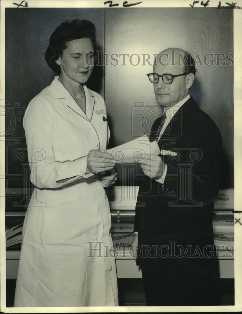 1963 Mrs. Evelyn Stumborg presents check to librarian Jerome Cushman - Historic Images
