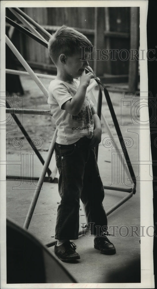 1968 George Clements playing in playground of the Day Care center - Historic Images