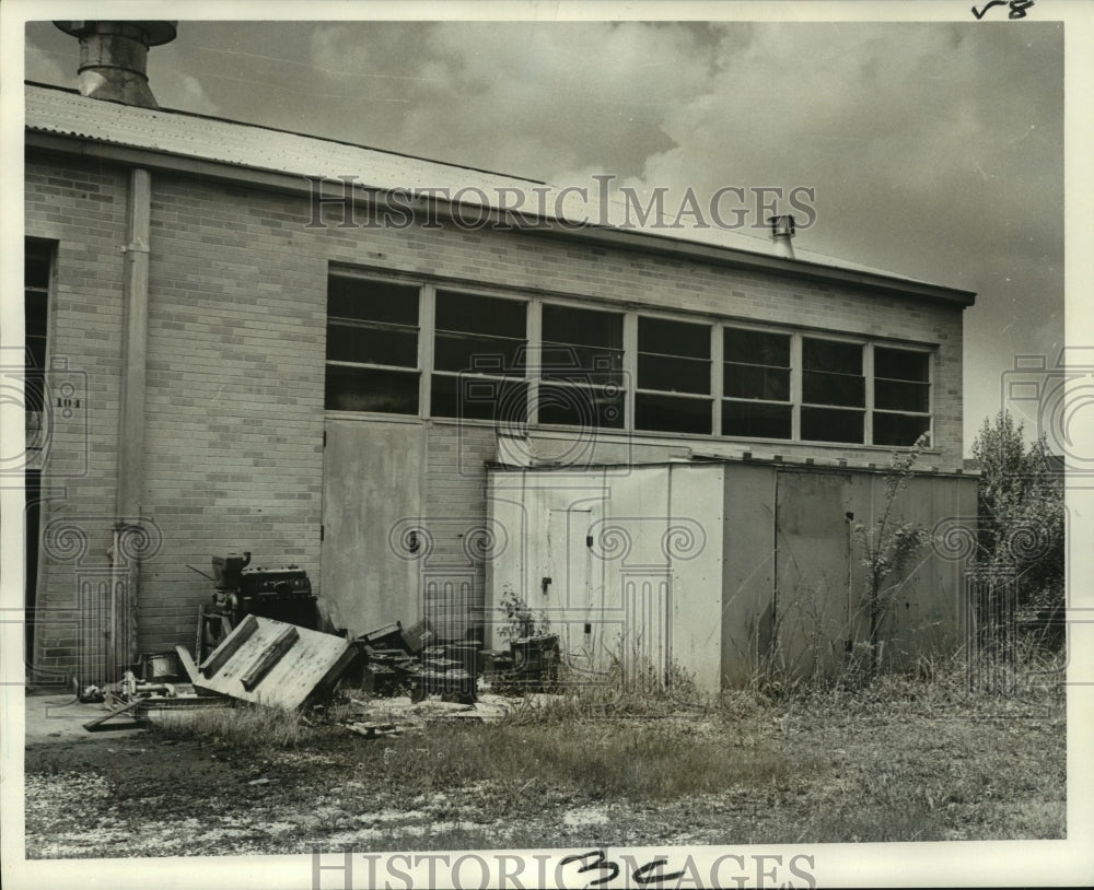 Old engine parts blocking doorway at Delgado Junior College - Historic Images