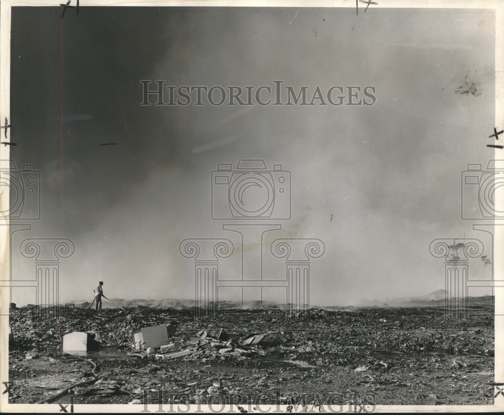 1969 Press Photo Lone attendant at Gentilly Road landfill sprays smoking fire - Historic Images