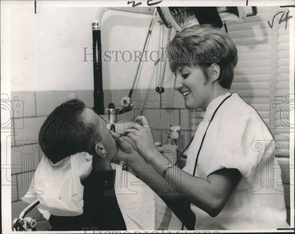 1966 Press Photo GI receives free dental attention from an attractive dentist-Historic Images