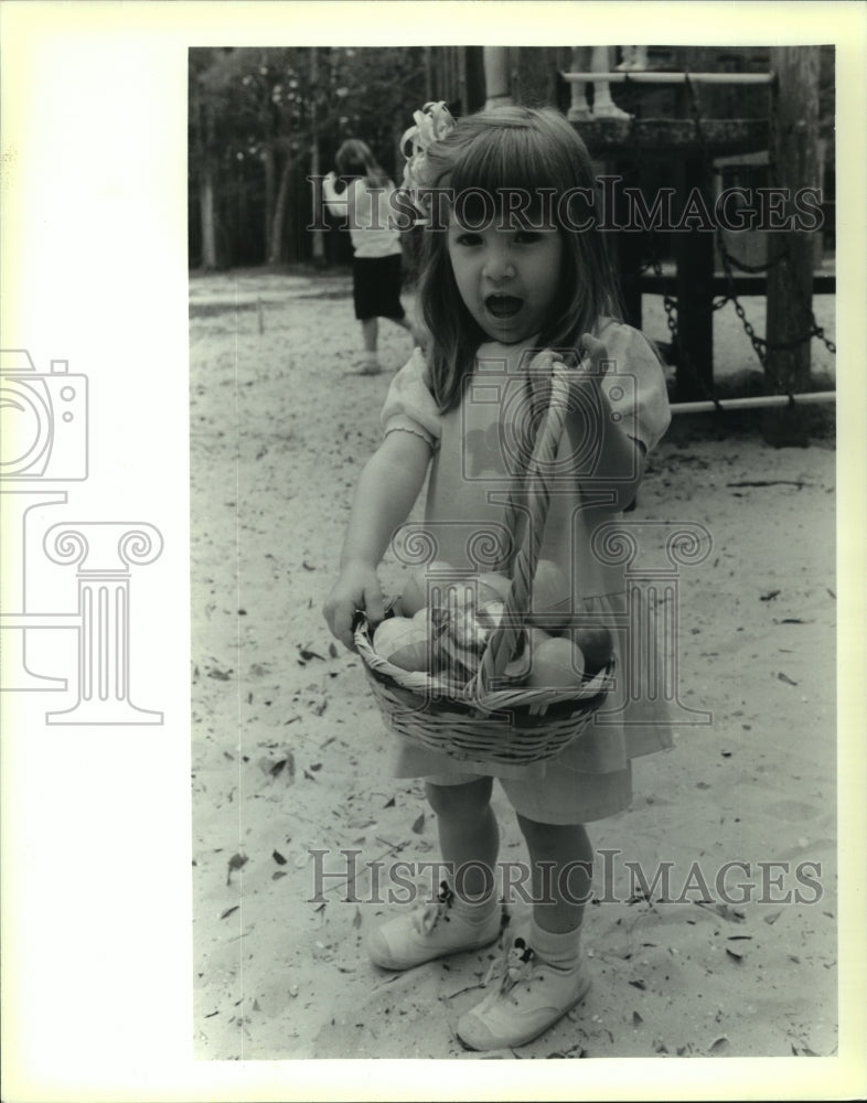 1991 Press Photo Blaire Barry with basket of found eggs during Easter Egg Hunt. - Historic Images