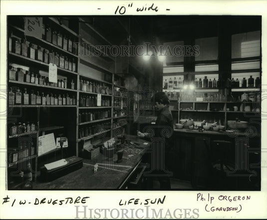 1986 Press Photo Remedies stored in glass containers & bare bulb lighting. - Historic Images