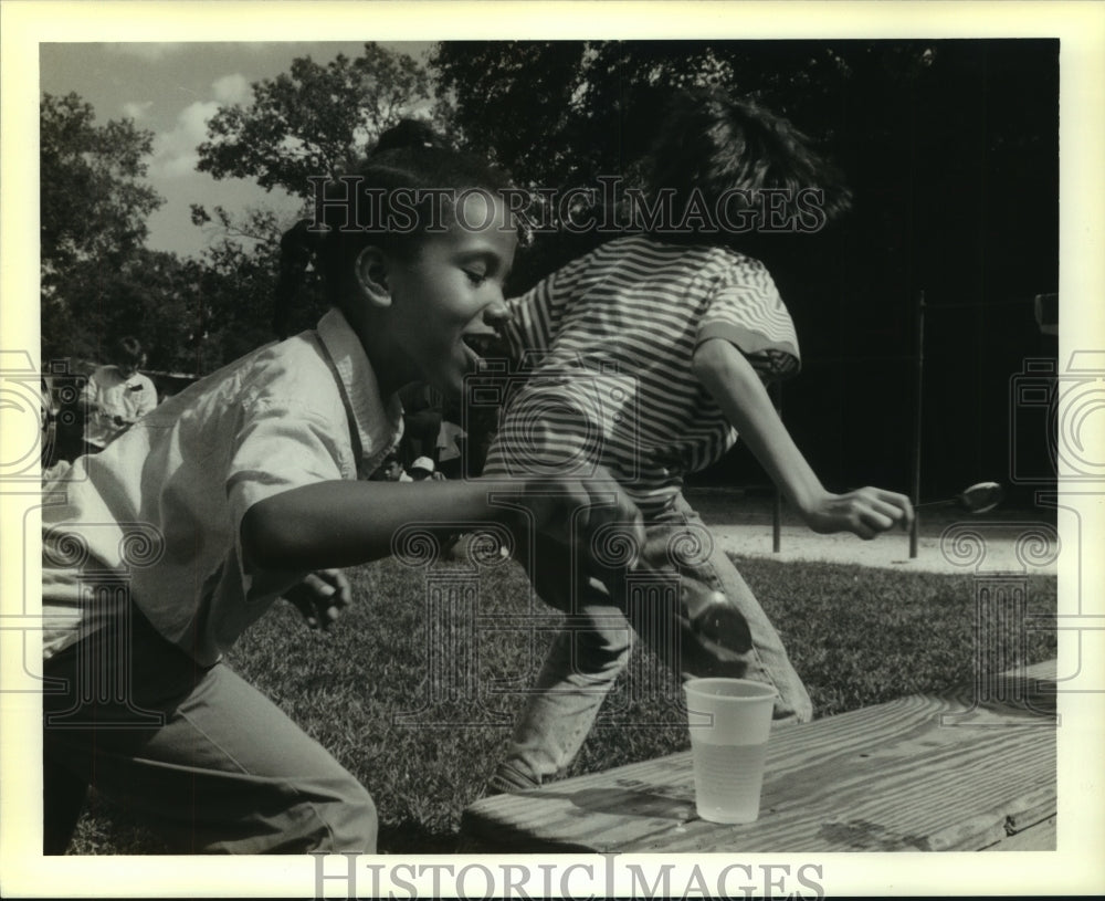 1989 Press Photo Maranda Banner fills water glass at Drug Awareness Day games. - Historic Images