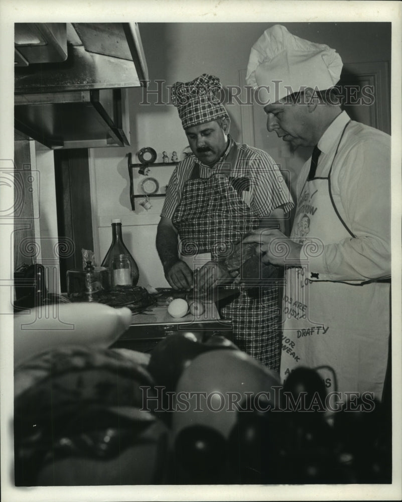 1967 Peter Dombourian teaches Milton  Bush to stuff grape leaves. - Historic Images