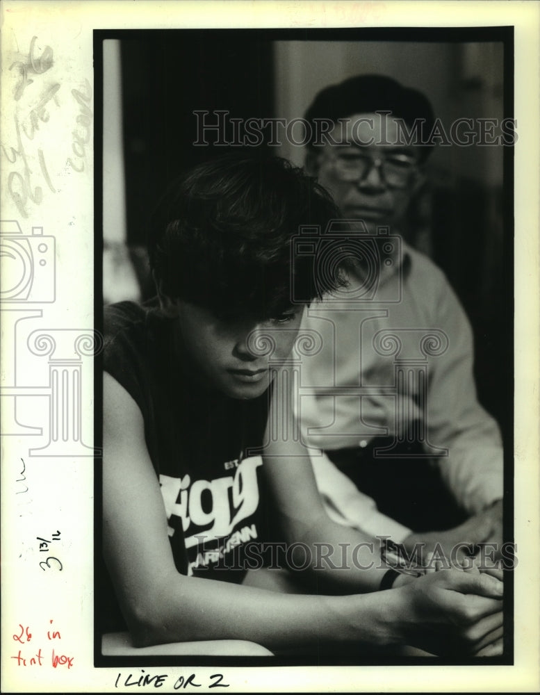 1988 Press Photo Duoing Thai Do talks about his father to Khang Nguyen - Historic Images