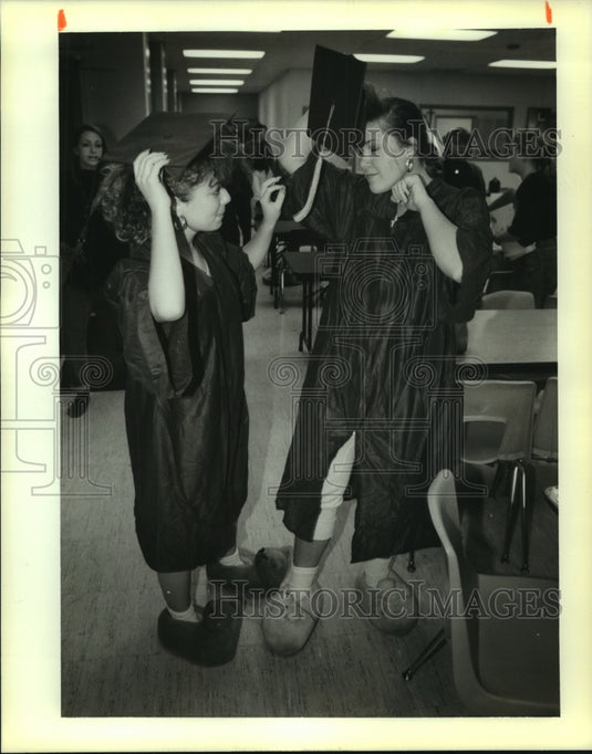 1989 Press Photo Seniors adjust caps during Twins Day at Pope John Paul II - Historic Images