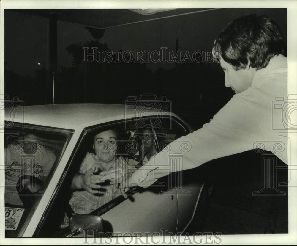 1977 Customers pay to attend the drive-in movie-Historic Images