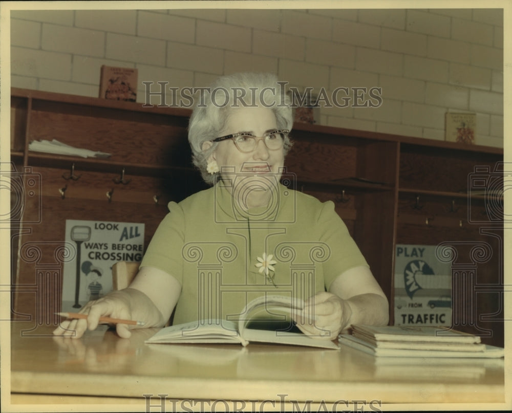 1969 Press Photo Mrs. Emily G. Emmer sits in front of safety posters at school. - Historic Images