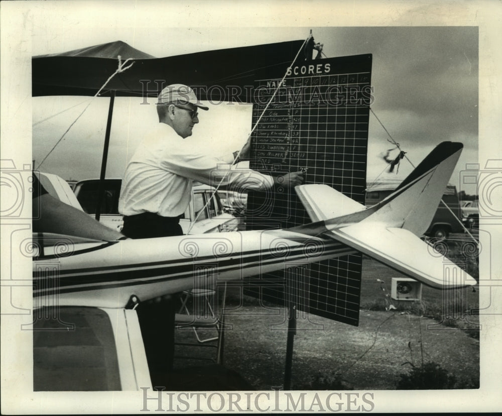 1964 Roy Kelly enters a model airplane contestant&#39;s score - Historic Images