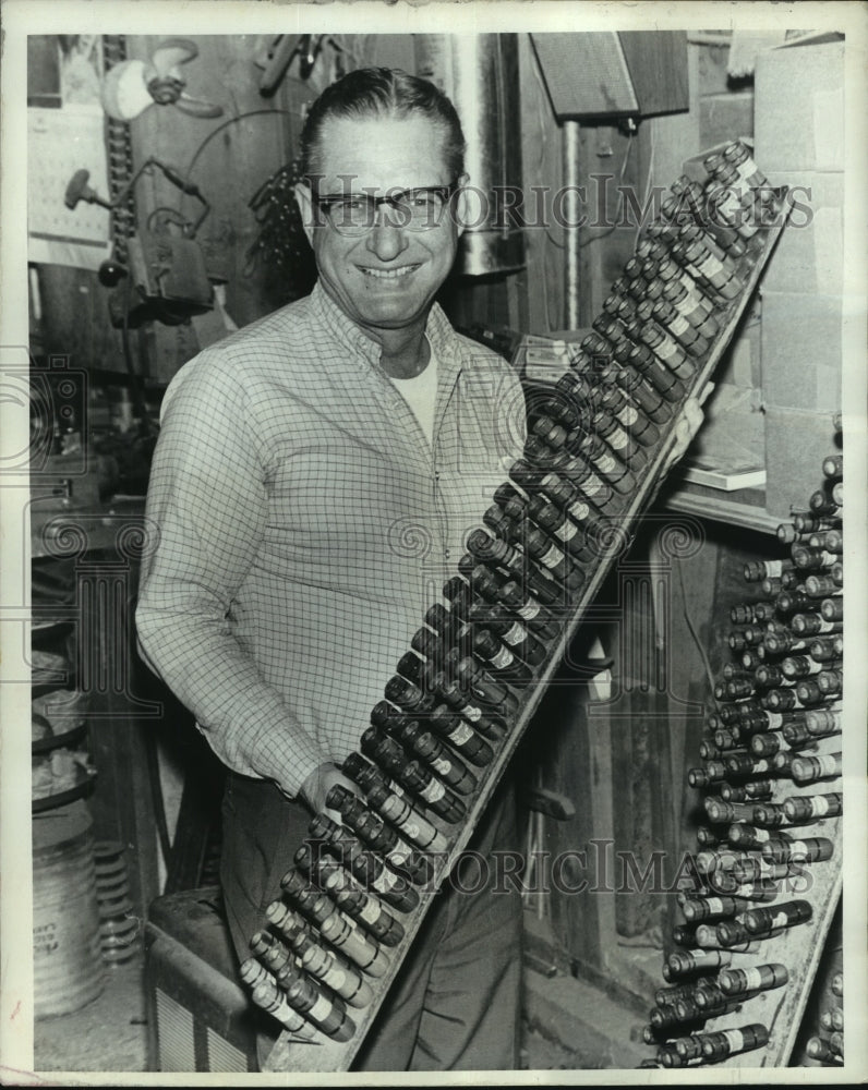 1973 Dud Faulk displays rack of finished crow calls - Historic Images