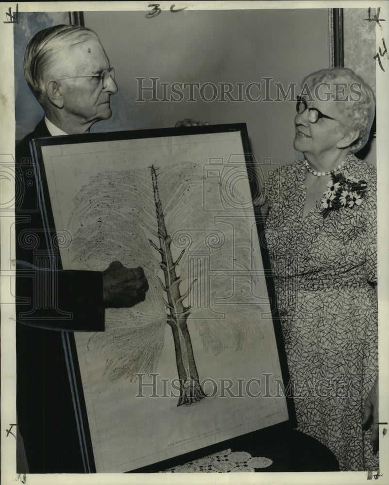 1958 Fred Drumm and Mrs. Drumm with the family tree. - Historic Images