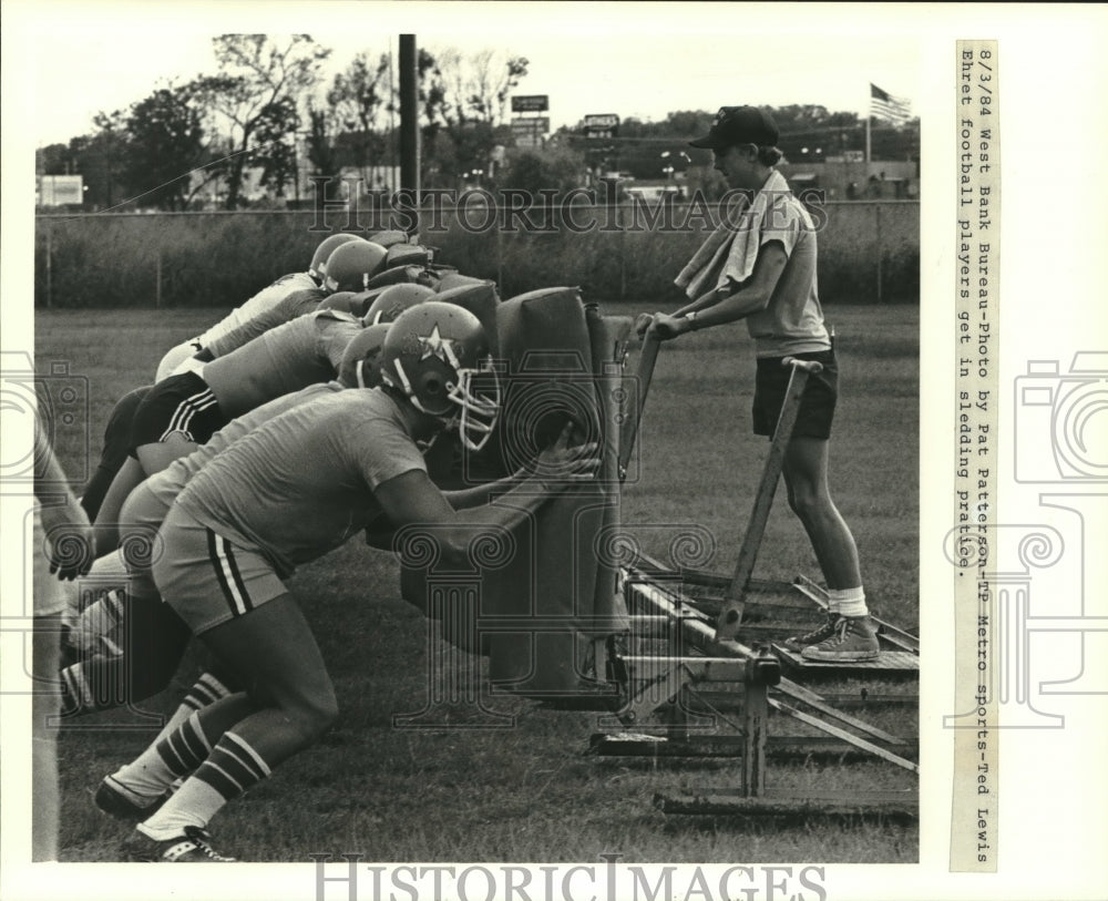 1984 Press Photo Football players of John Ehret High during sledding practice - Historic Images