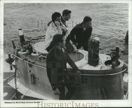 1969 Flight Recorder atop submarine Deep Quest with sub's crew. - Historic Images