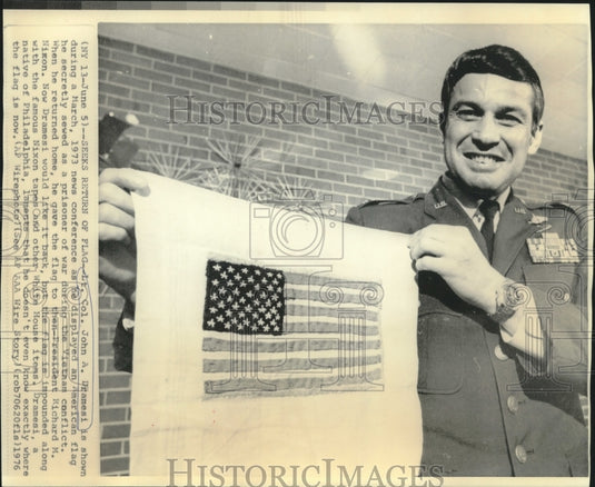 1976 Lt. Col. John a. Dramesi displays flag he sewed as Vietnam POW-Historic Images