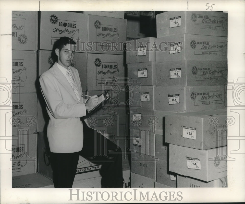 1953 Press Photo Thomas Favrot, president of Eaco, Incorporated checks stock - Historic Images