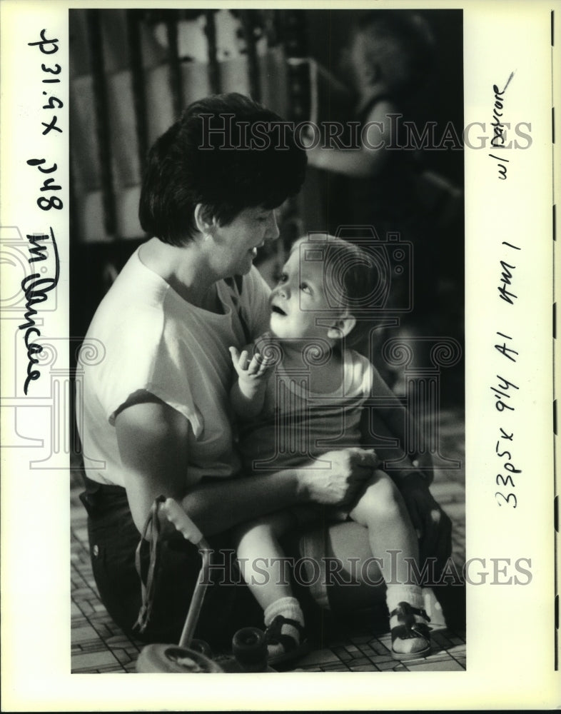 1991 Press Photo Juana Barrerio holds a child at Enchanted World Daycare Center - Historic Images