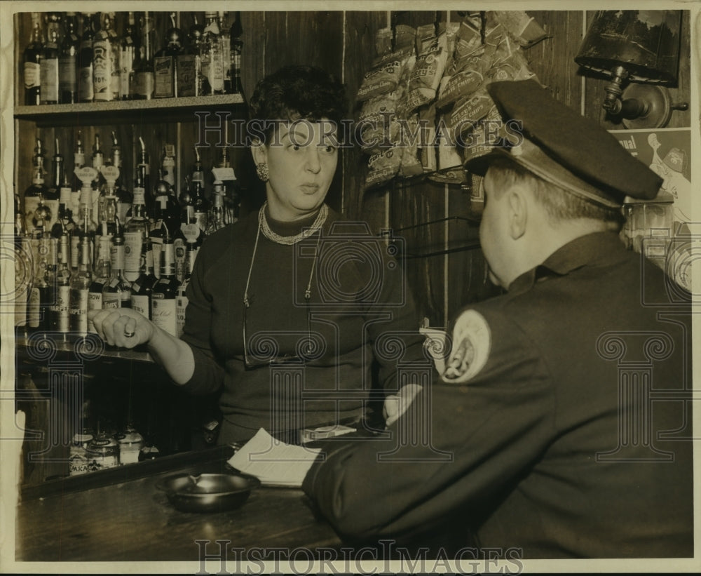 1963 Mrs. Lillyan Ferrera, Bon Soir Bar, talks to police officer.-Historic Images