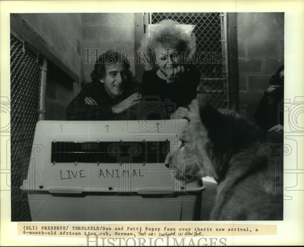 1990 Endangered Species Center employees with African Lion cub - Historic Images