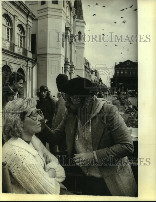 1988 Press Photo A women sits patiently as she has her face painted. - Historic Images