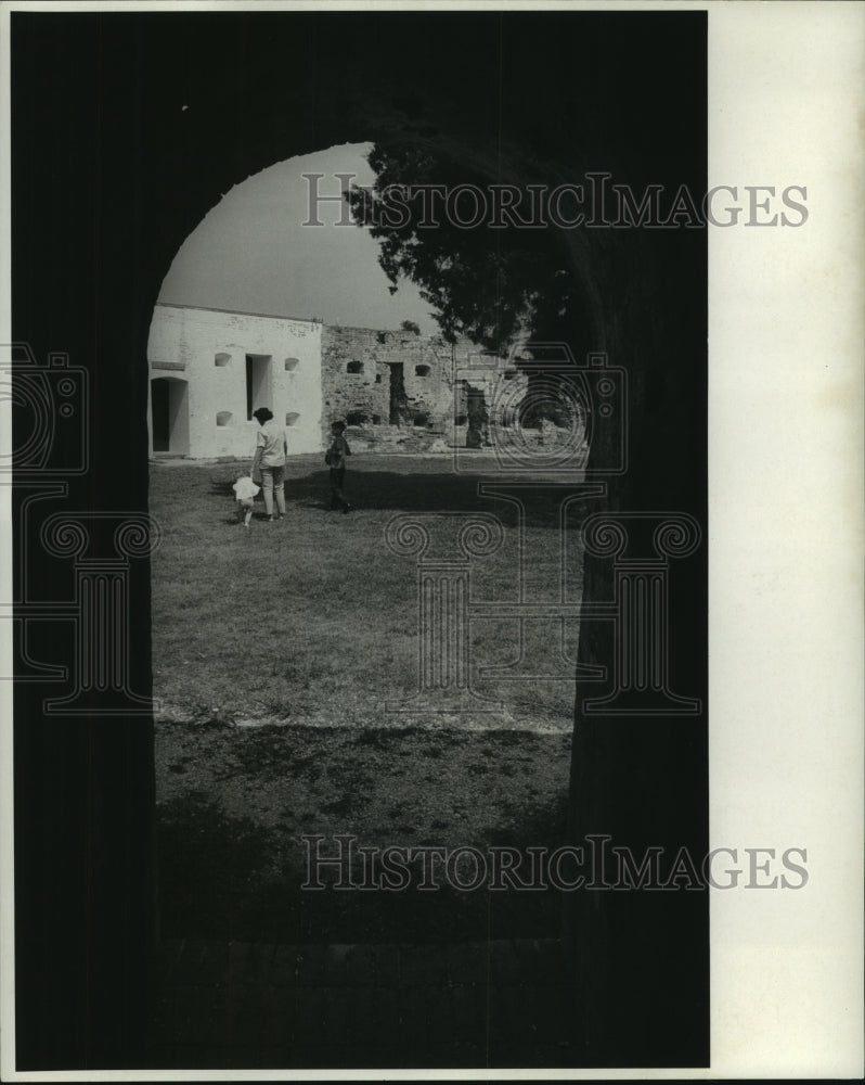1969 Press Photo A man and children walk outside the Fort Pike - nob05832 - Historic Images