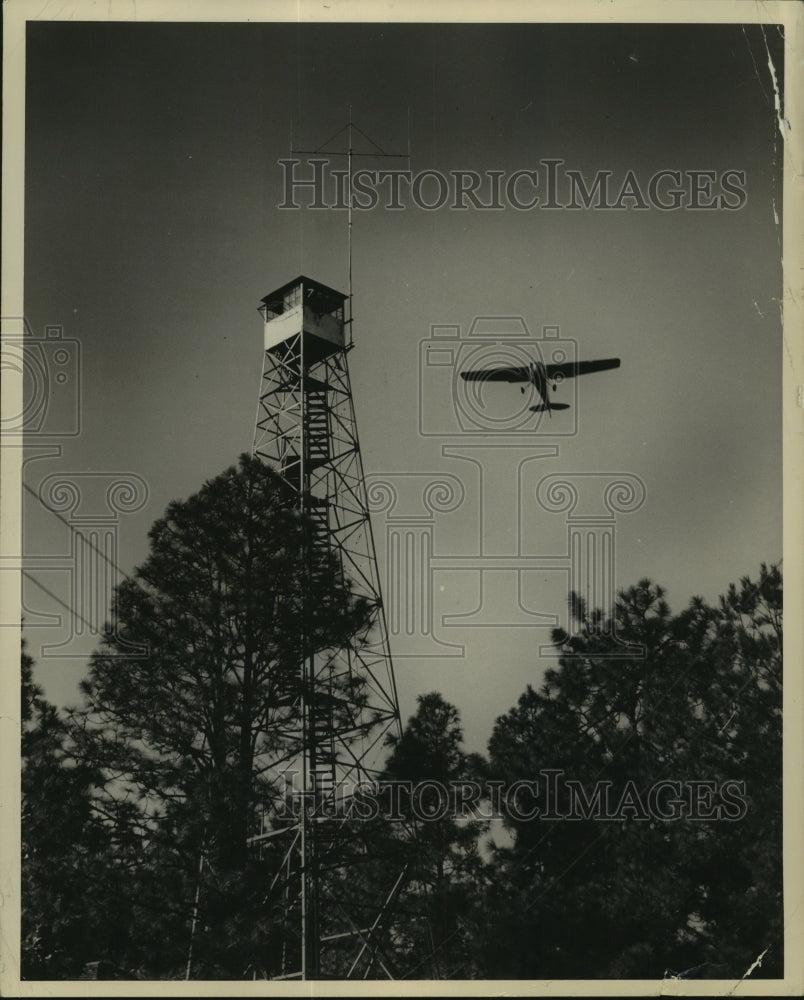 Press Photo Plane flies over forest fire and fire tower  in Louisiana - Historic Images