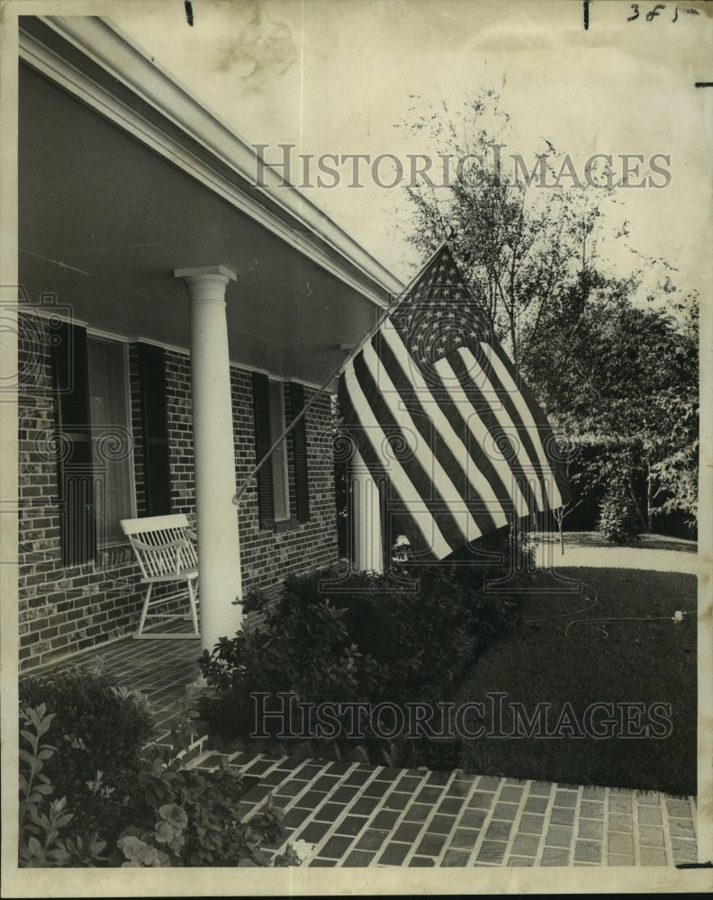 1969 American flag on display at home of 1240 Brockenbraugh Court - Historic Images