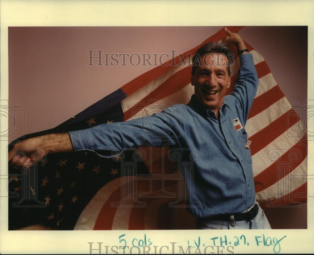 1994 Press Photo An unidentified man holding the American Flag - Historic Images