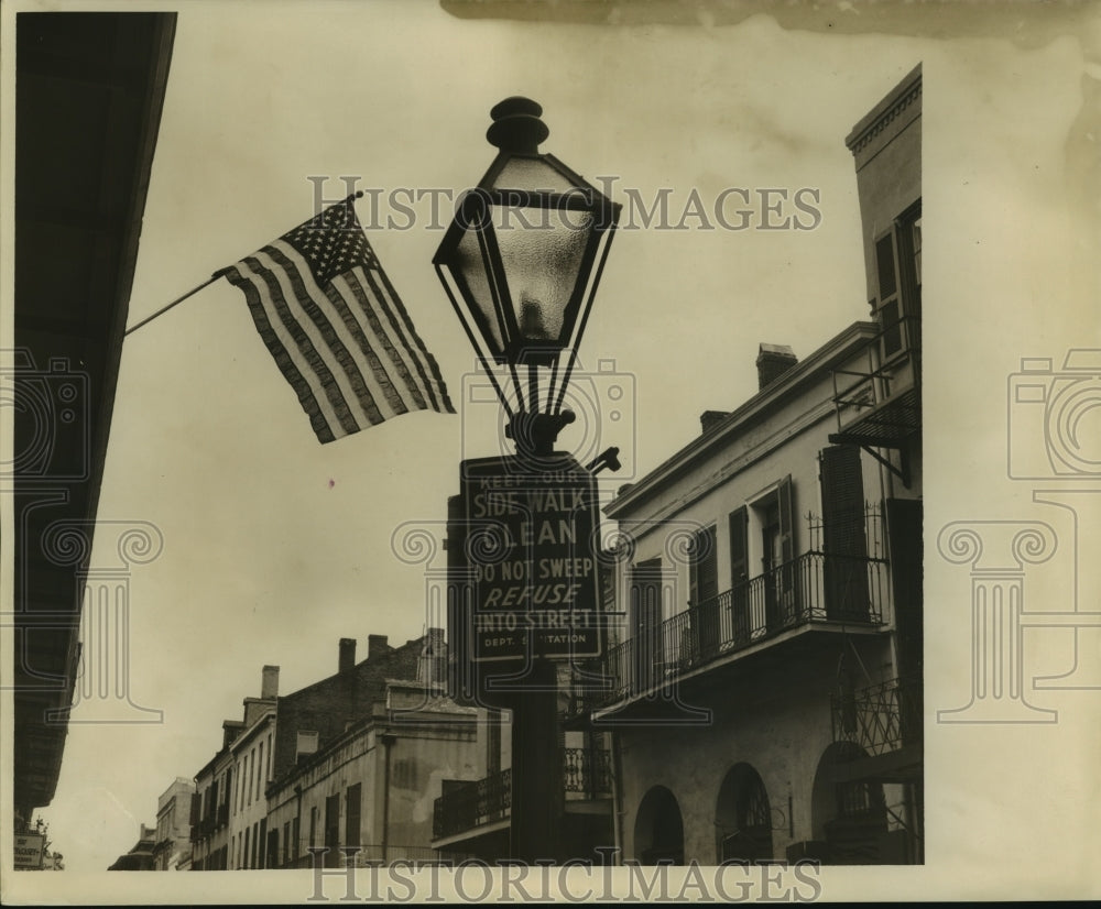 1962 Press Photo The flag flies over a public service sign on Flag Day. - Historic Images