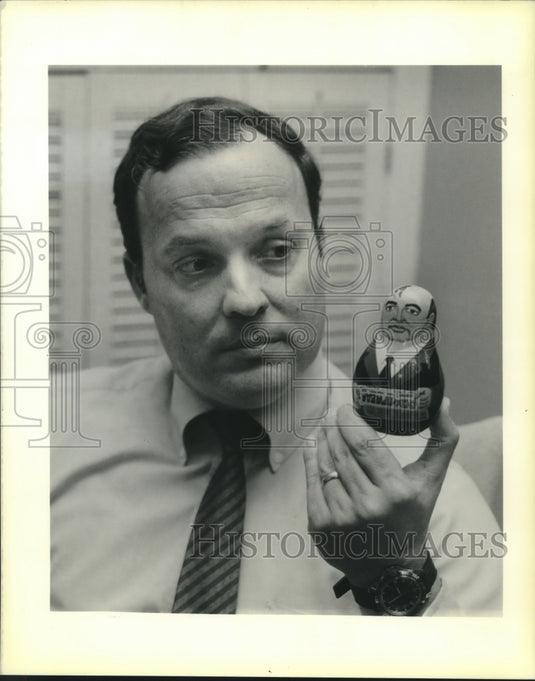 1990 Press Photo John Exnicios holds doll replica of President Mikhal Gorbachev - Historic Images