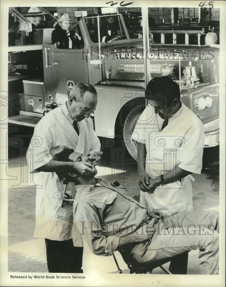 1968 Firefighter participating in a peridontal disease study. - Historic Images