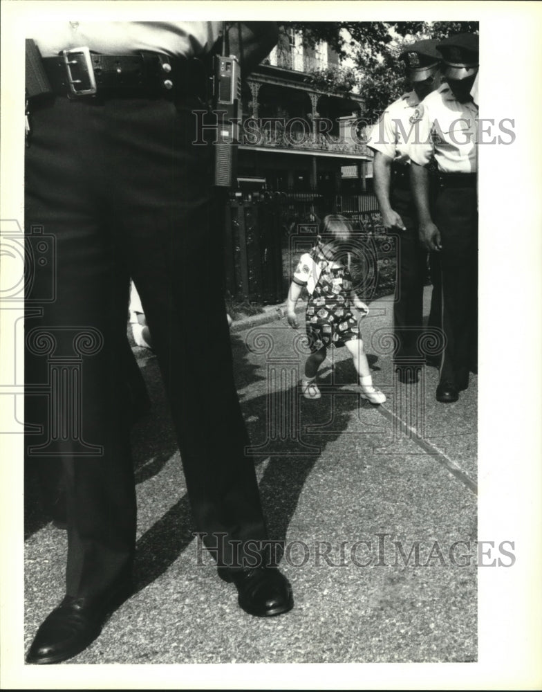 1992 Press Photo Richie Scheurman stands in the shadow of police and firemen. - Historic Images