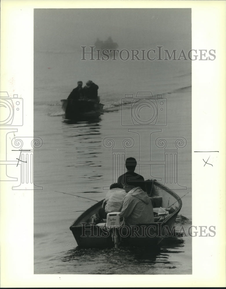 1988 Press Photo Residents shown fishing despite the fog - Historic Images